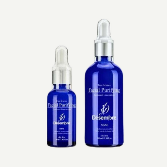 Desembre pure science facial purifying serum in a royal blue bottle